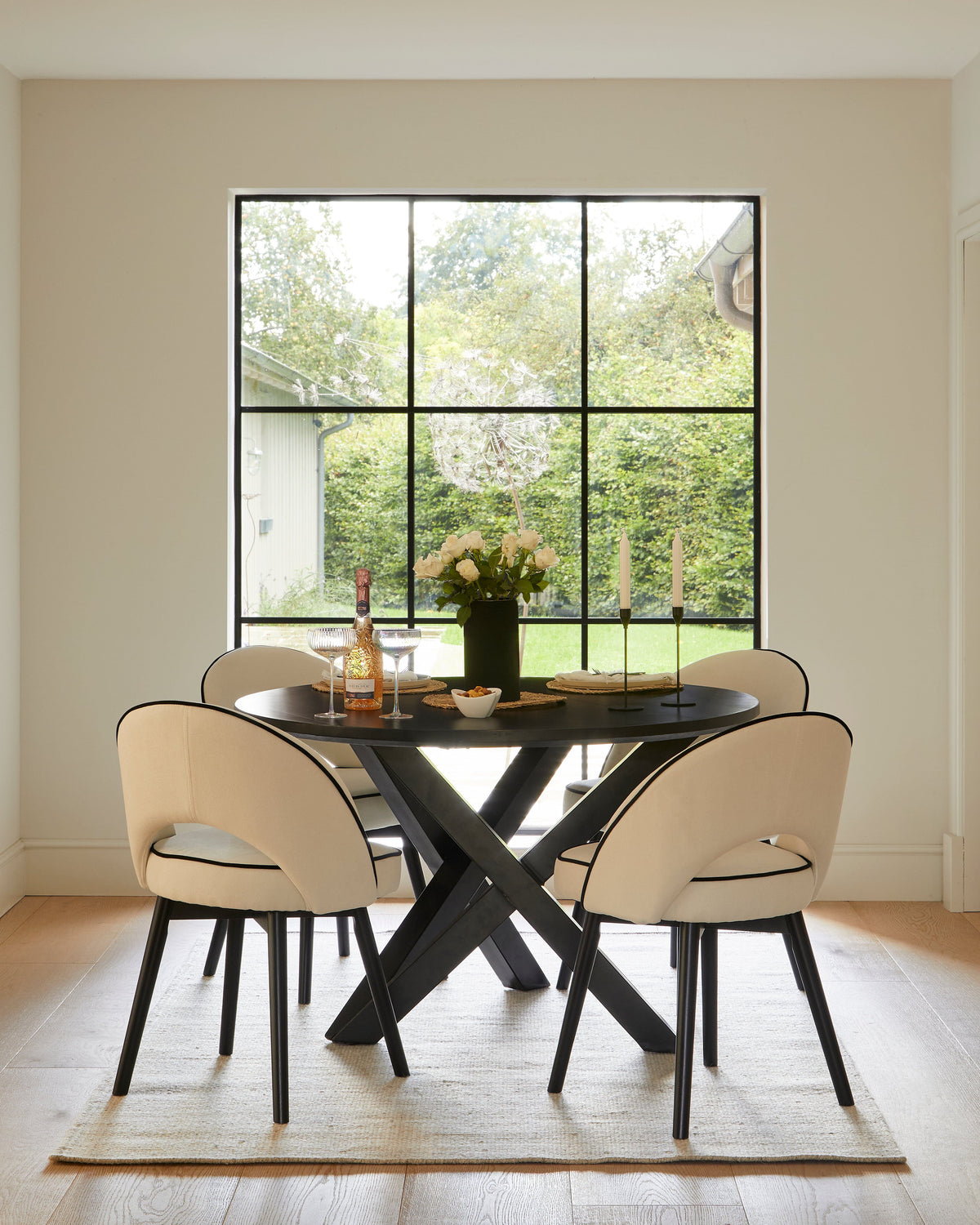 Levi Black Round Dining Table Set - 4 Seater - Marilyn Ivory Dining Chairs with Black Legs - Laura James