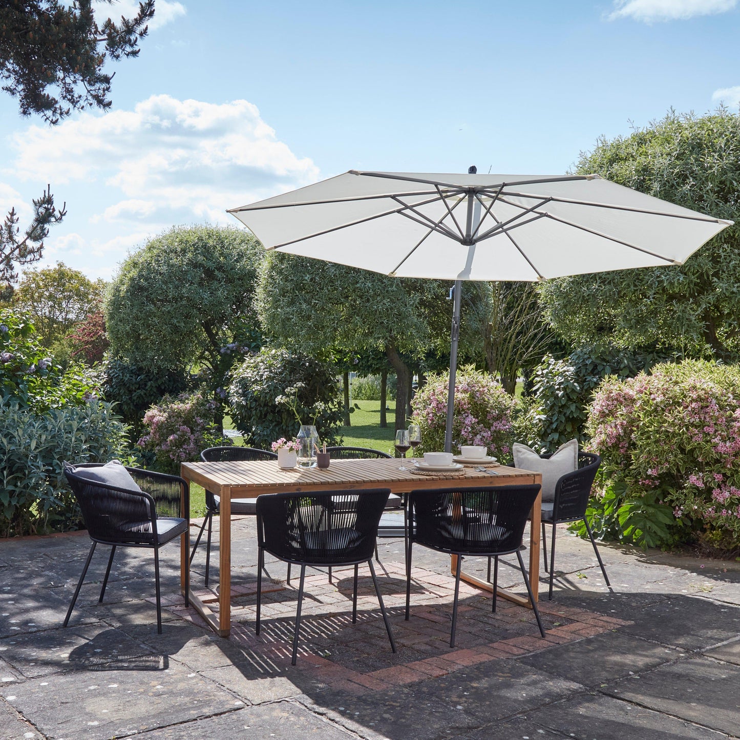 Lennox Table With 6 Hali Black Dining Chairs and Cream Lean Over Parasol