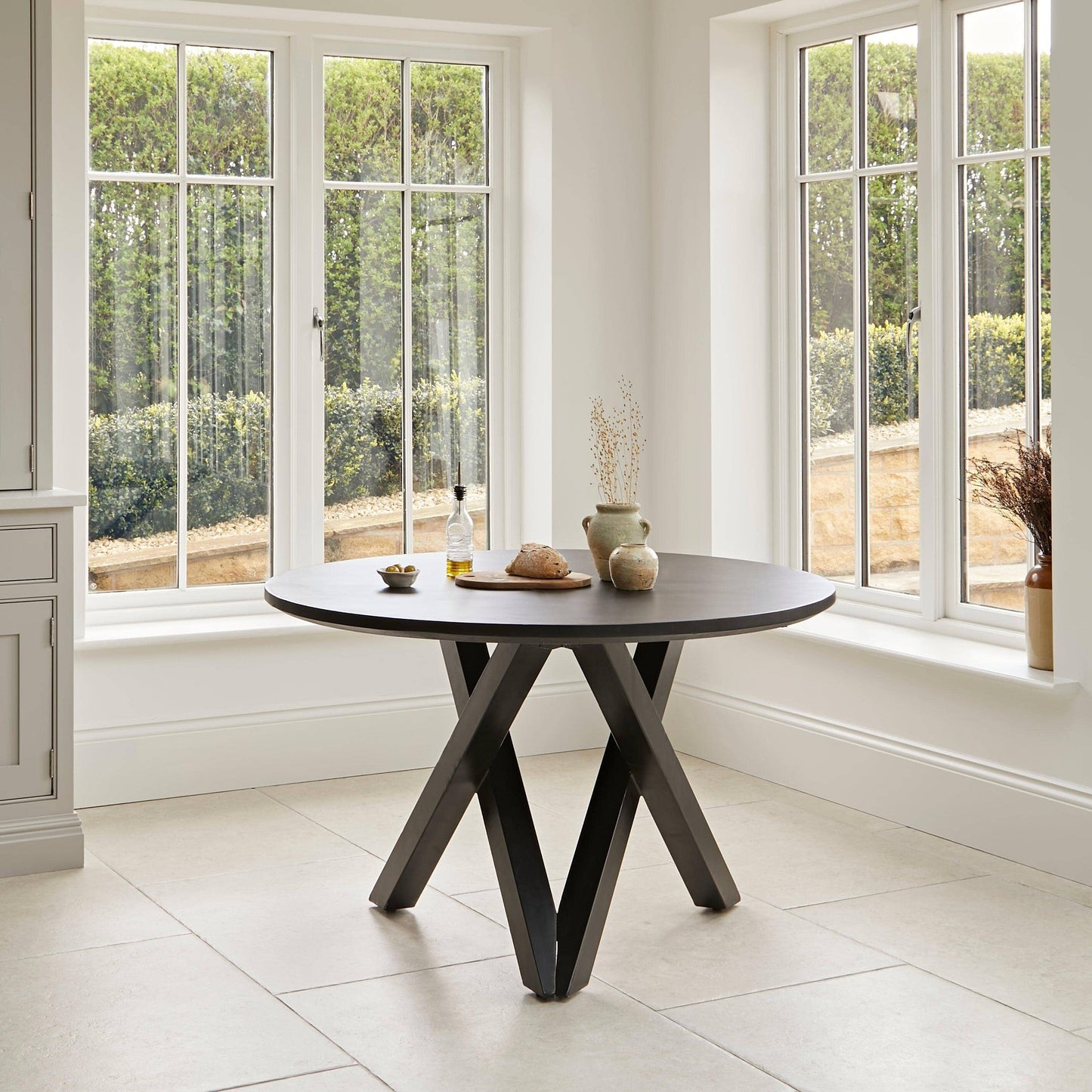 Levi Black Round Dining Table Set - 4 Seater - Freya Oatmeal Dining Chairs with Black Oak legs - Laura James