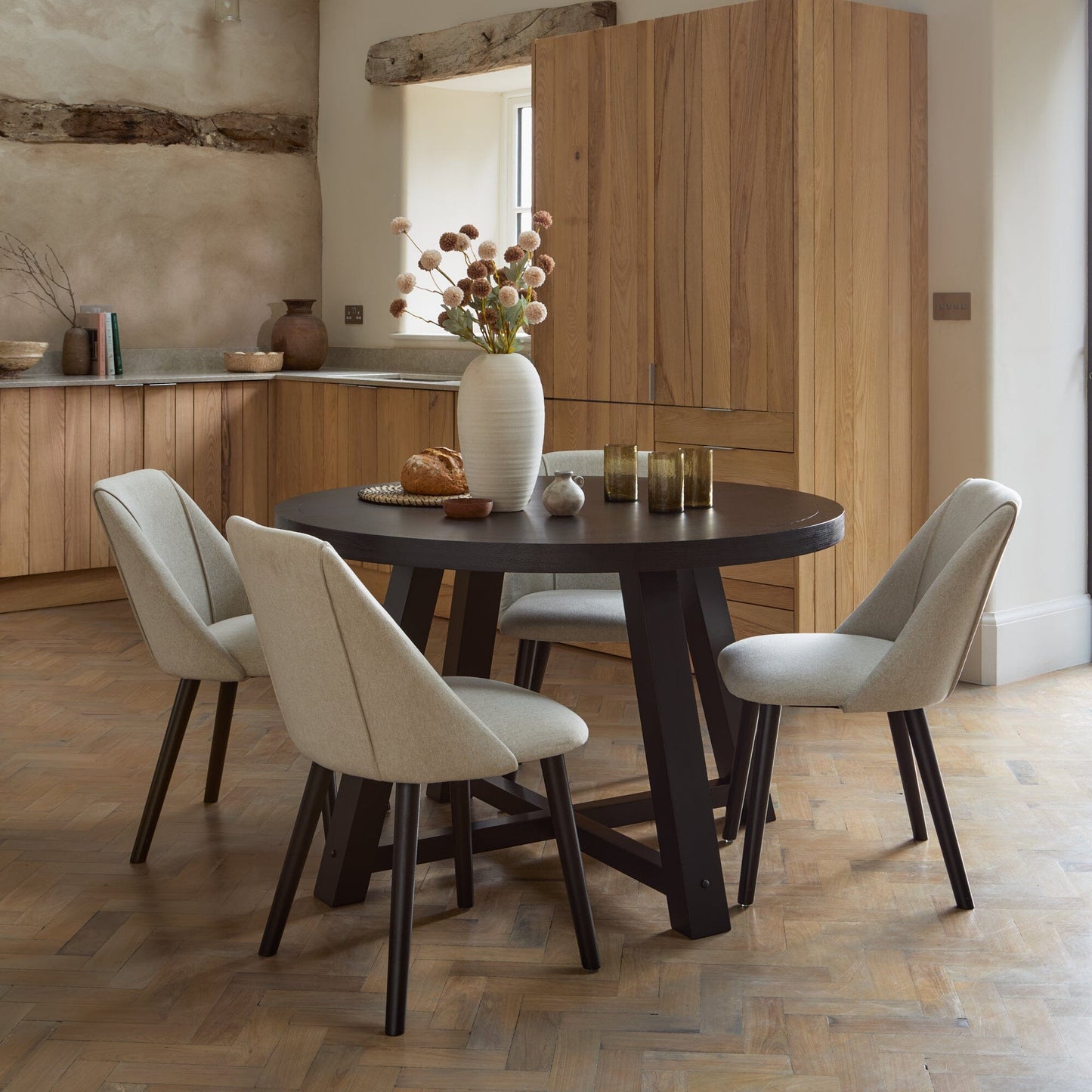 Charlotte Black Oak Round Dining Table Set - 4 Seater - Freya Sand Dining Chairs - Black Oak Legs - Laura James