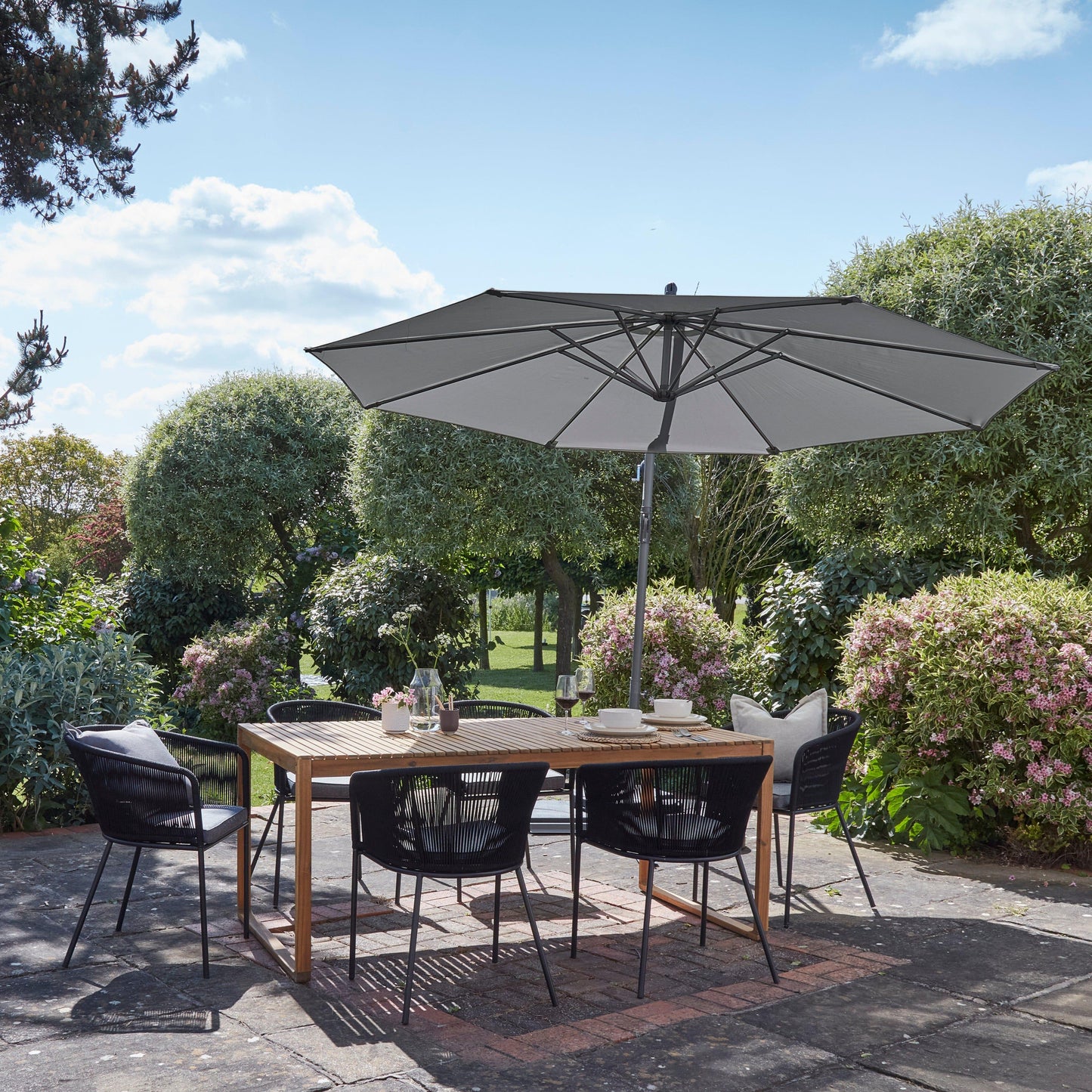 Lennox Table With 6 Hali Black Dining Chairs and Grey Lean Over Parasol